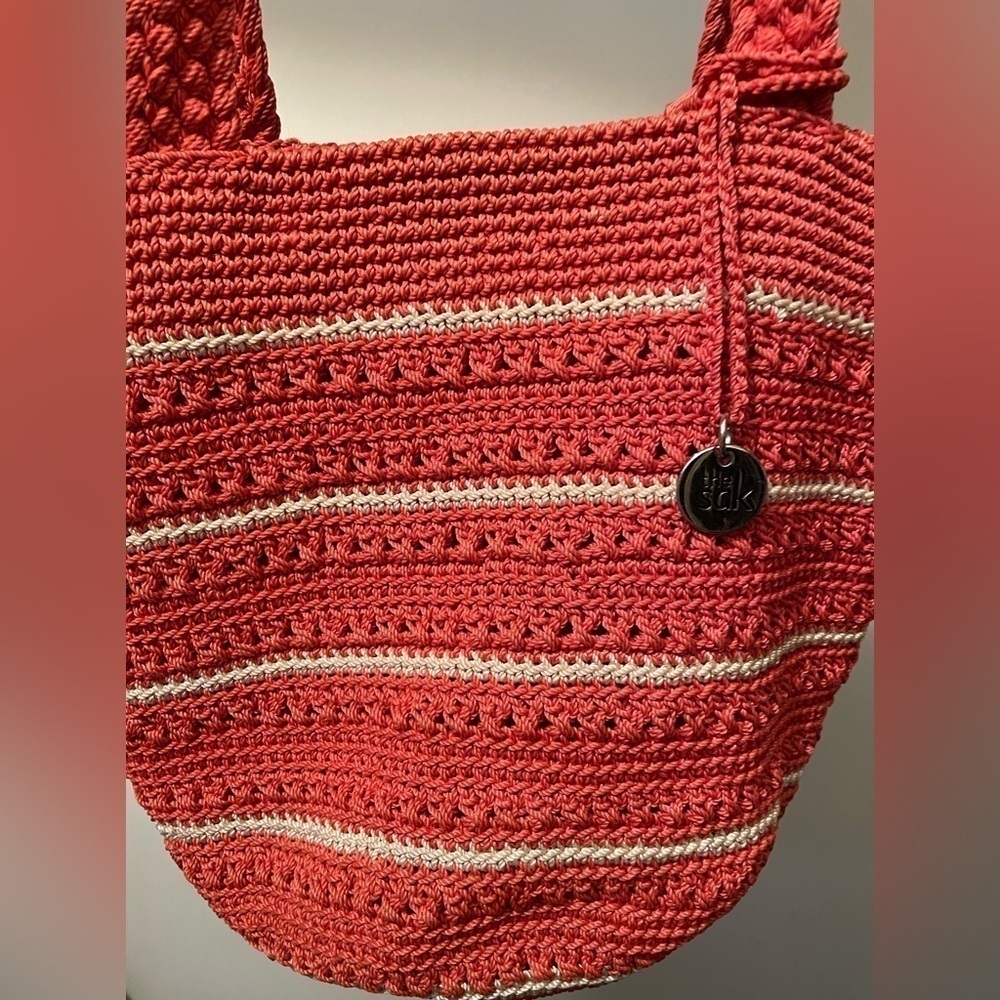 The Sak Bag . Sak Coral Salmon colored Crochet round bottom strip purse